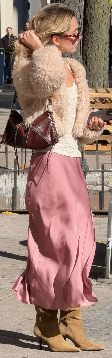 Cream fuzzy jacket, white lace top, pink satin skirt, and tan suede ankle boots.
