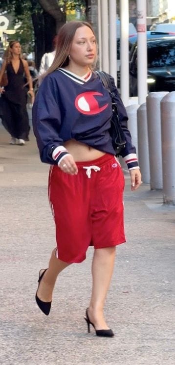Navy Champion V-neck top, red basketball shorts, and black slingback heels.