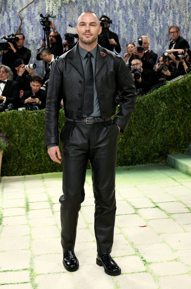 Black cropped leather jacket, gray shirt, black tie, black leather pants, and black boots.