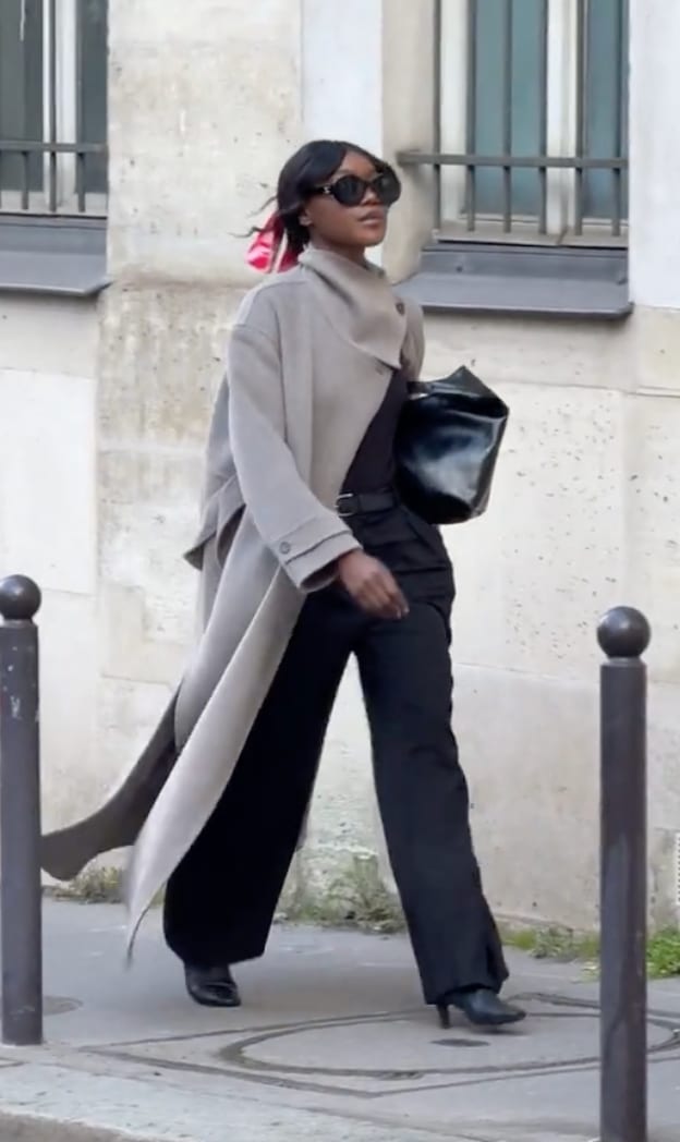 Long gray coat, black wide-leg pants, black top, black heels, and sunglasses.