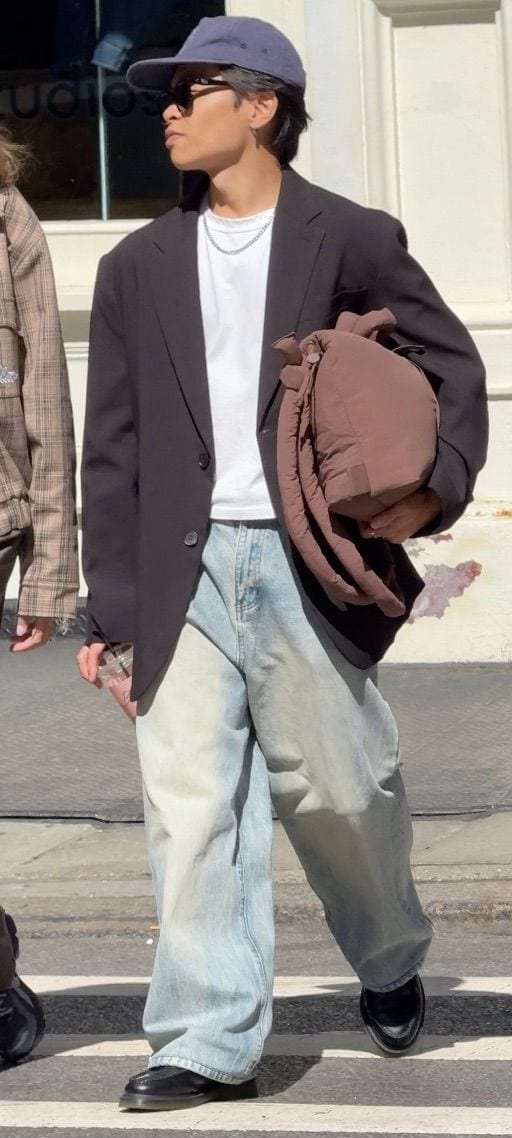 Black blazer, white t-shirt, baggy light-wash jeans, black loafers, and a navy baseball cap.