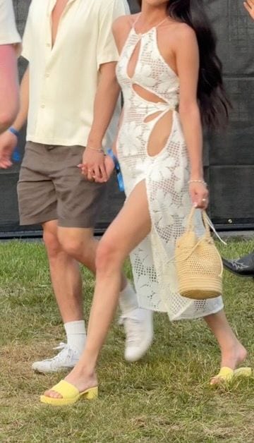 White crochet cutout dress with side slit, yellow mules, and straw bag.