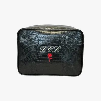 Black crocodile embossed bag with silver "DCL" initials and a red rose emblem.