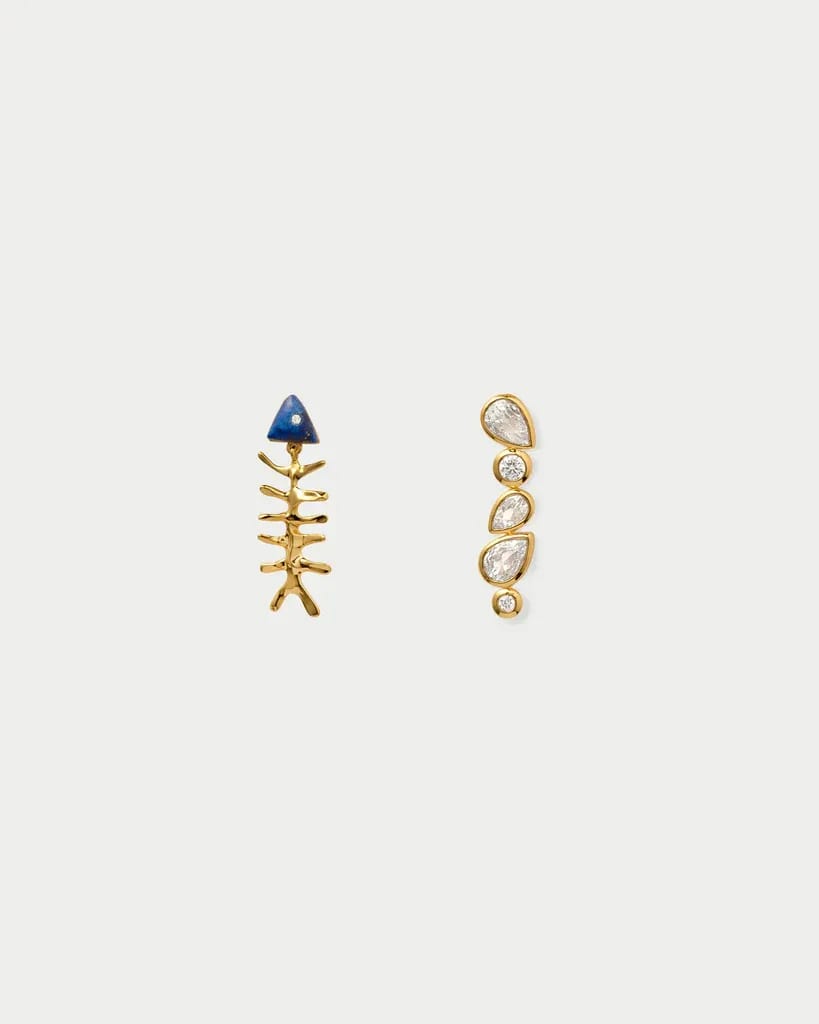 Gold fish bone earring with blue and diamond accents; gold diamond drop earring.