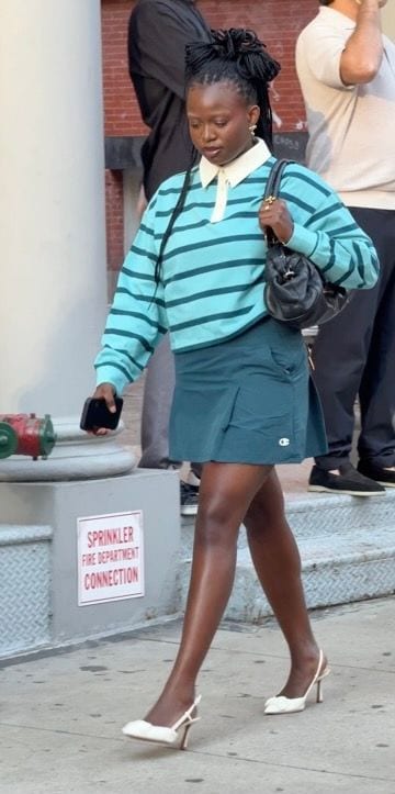 Aqua striped polo shirt with a teal mini skirt, white slingback heels, and a black bag.