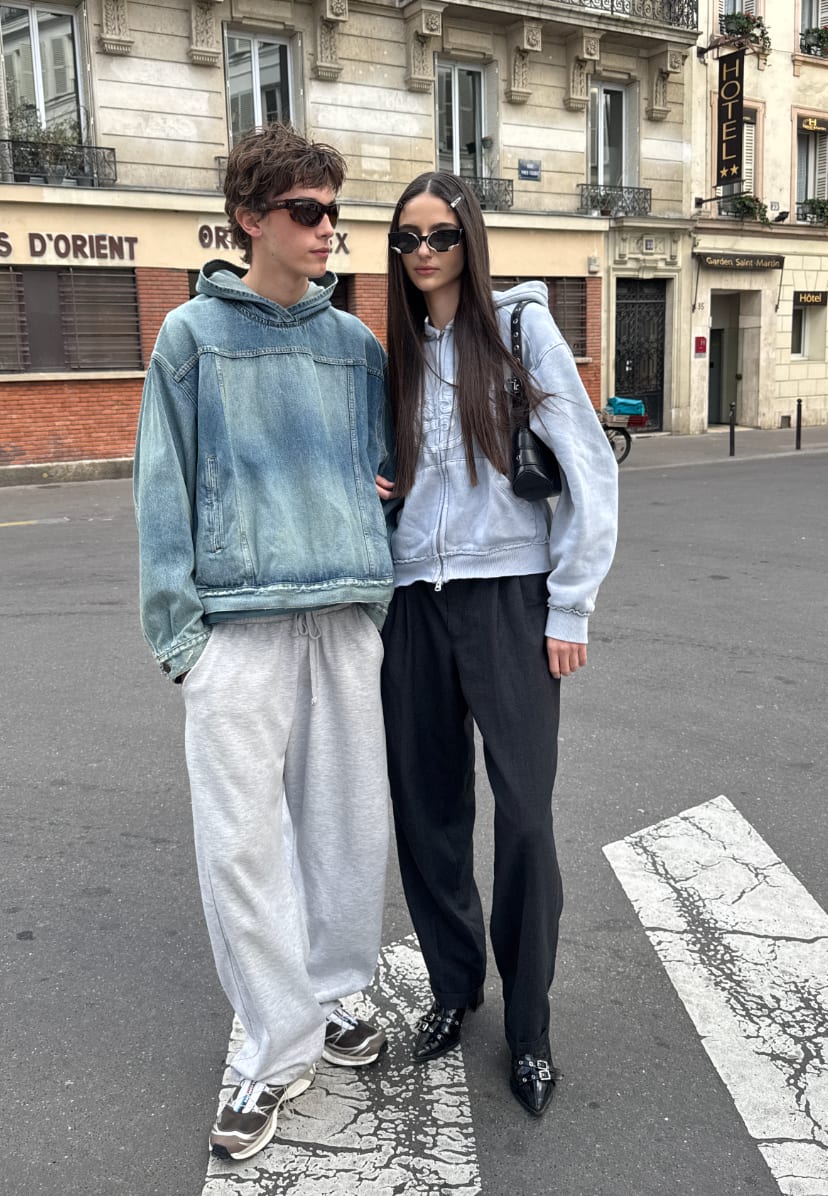 Denim hooded jacket, gray sweatpants, light blue zip hoodie, black trousers, and buckled shoes.