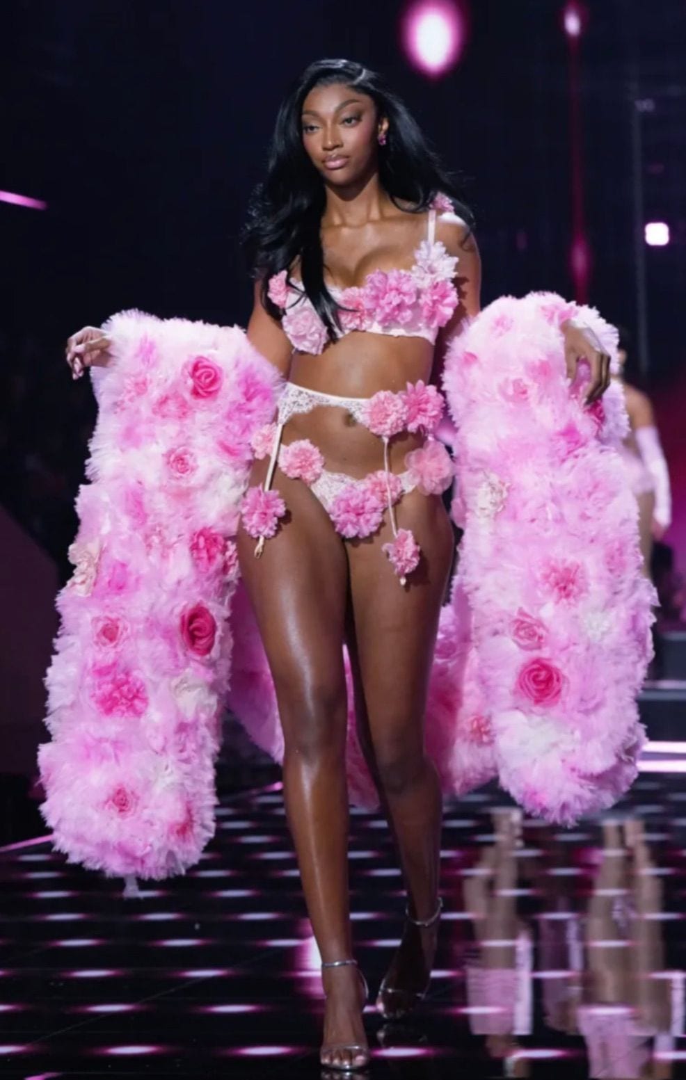 Pink floral lingerie with matching fluffy robe on a runway.