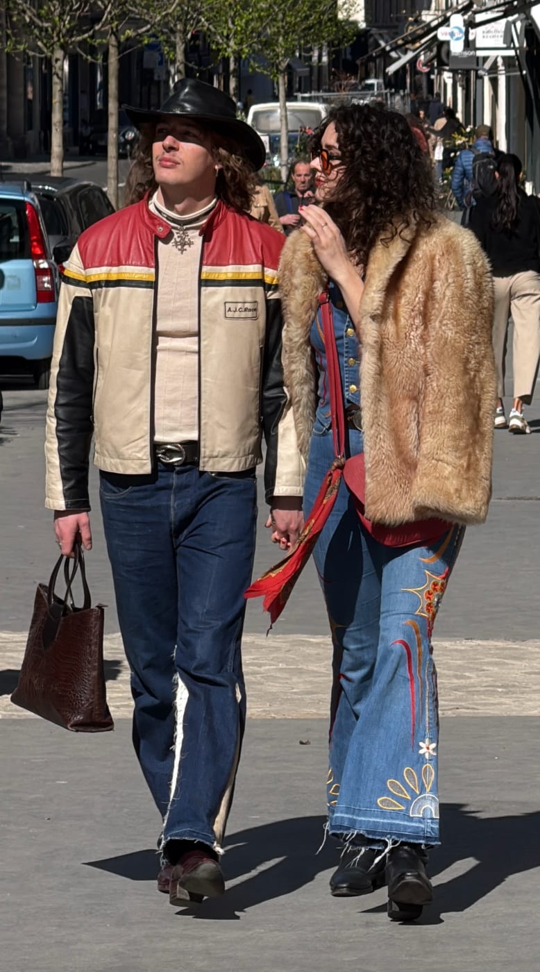 Western-inspired couple in a vintage racing jacket, embroidered denim, and a fur coat.