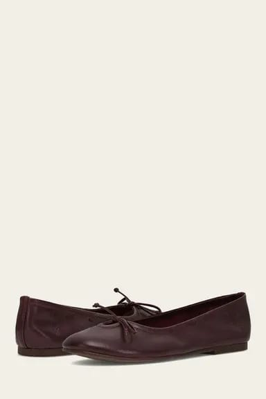 Dark red leather ballet flats with bow detail.