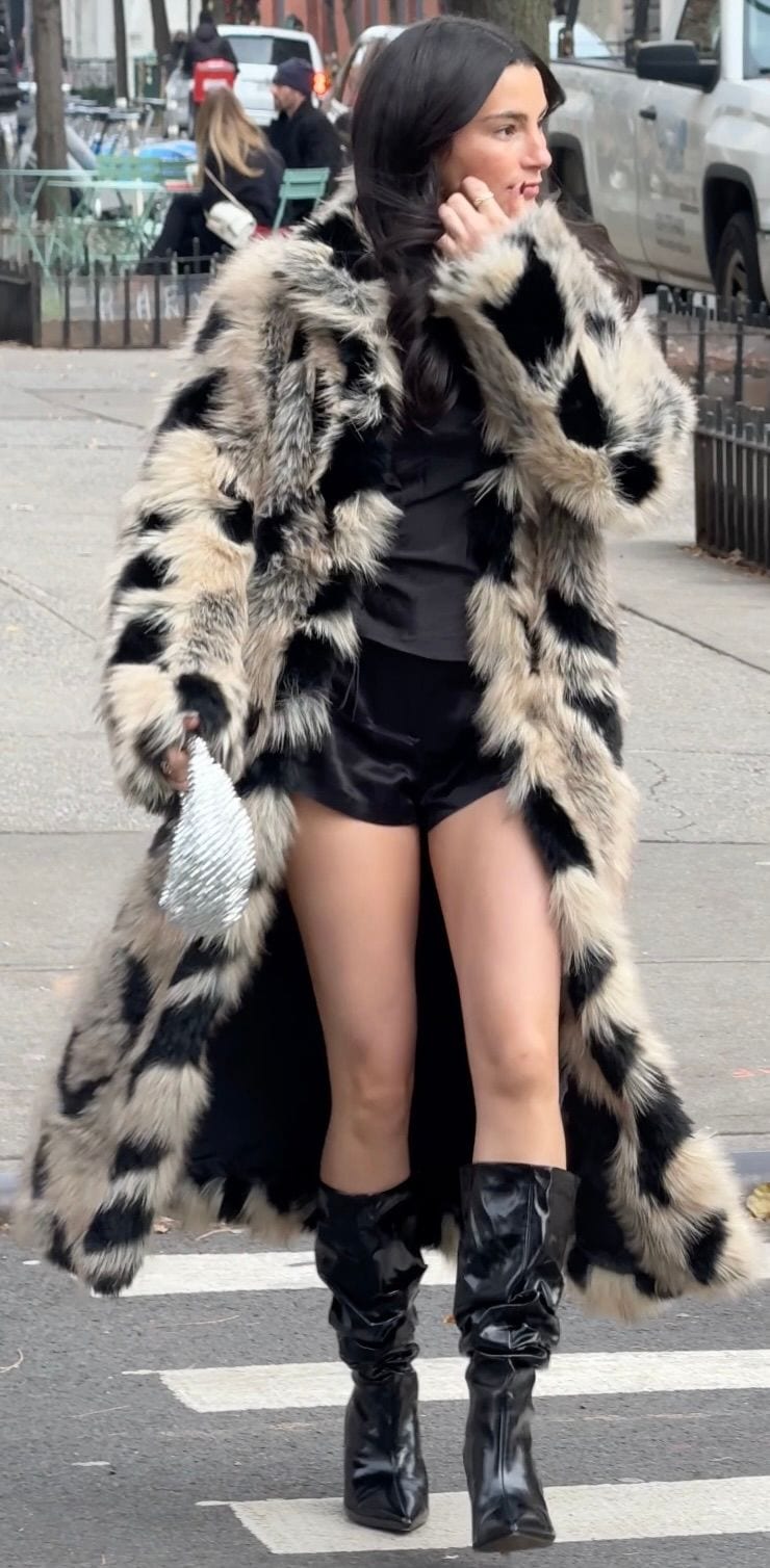 Black and white leopard print faux fur coat with satin shorts and shiny black boots.