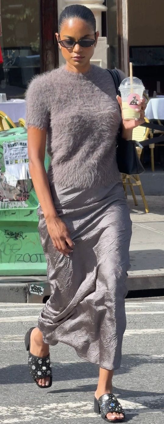 Gray fuzzy short-sleeve top, silver ruched midi skirt, black studded mules, and sunglasses.