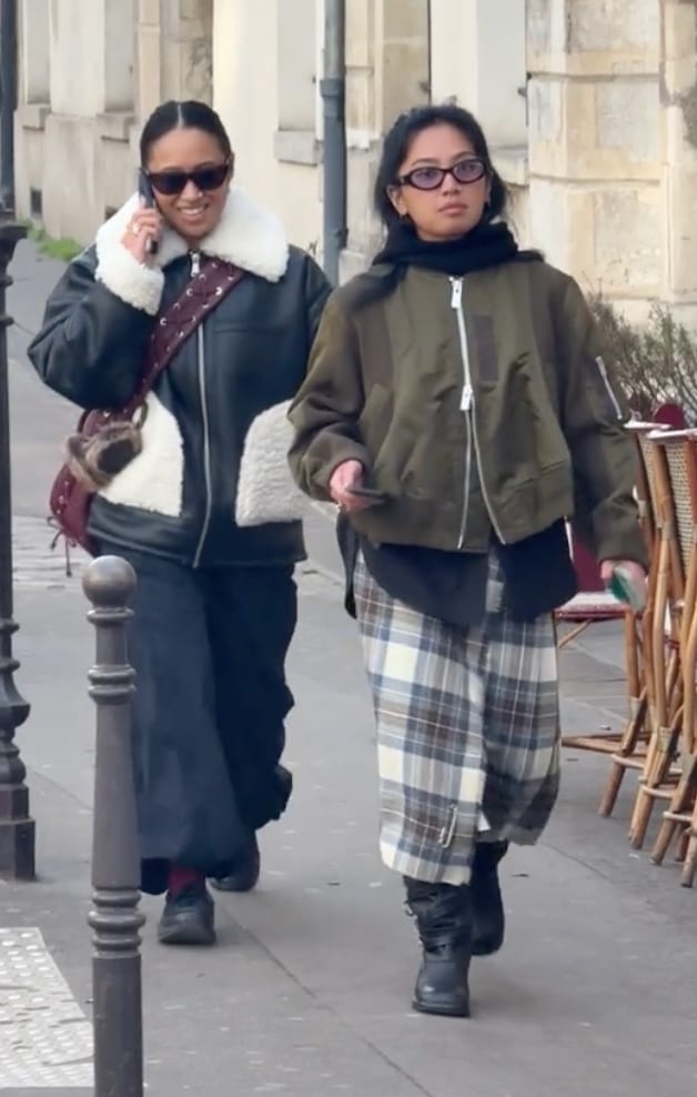 Black shearling aviator jacket, dark cargo pants, and a plaid midi skirt with an olive bomber.