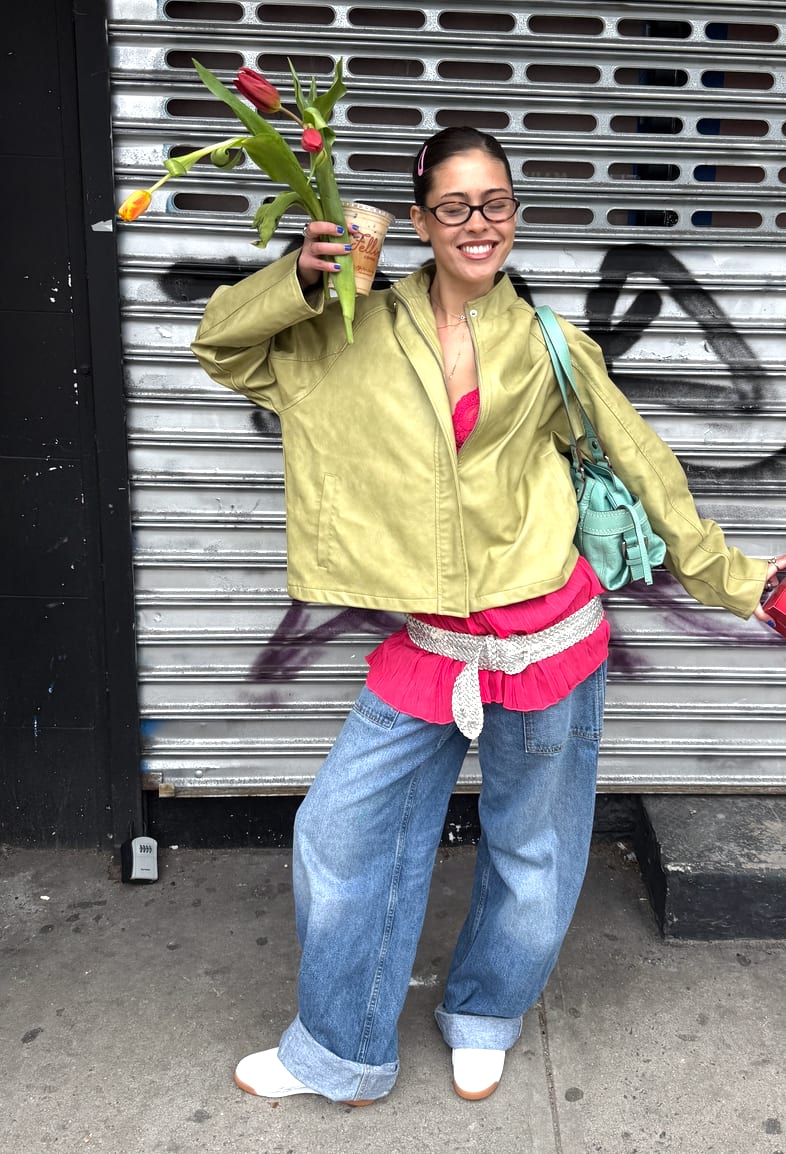 Lime green jacket, hot pink top, wide-leg jeans, and white sneakers with tulips.