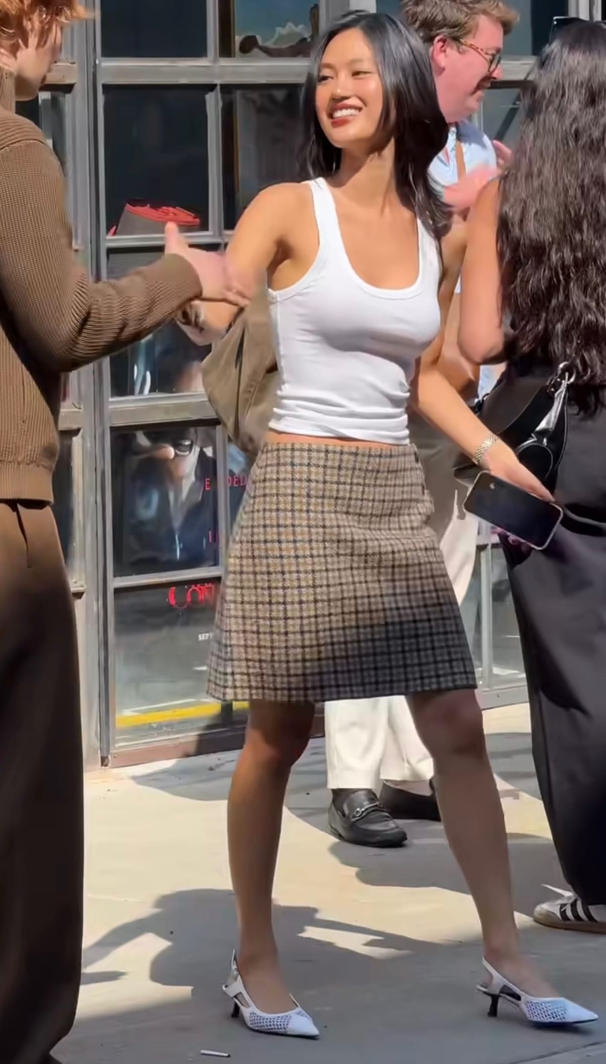 White tank top, brown plaid mini skirt, and white mesh slingback heels.