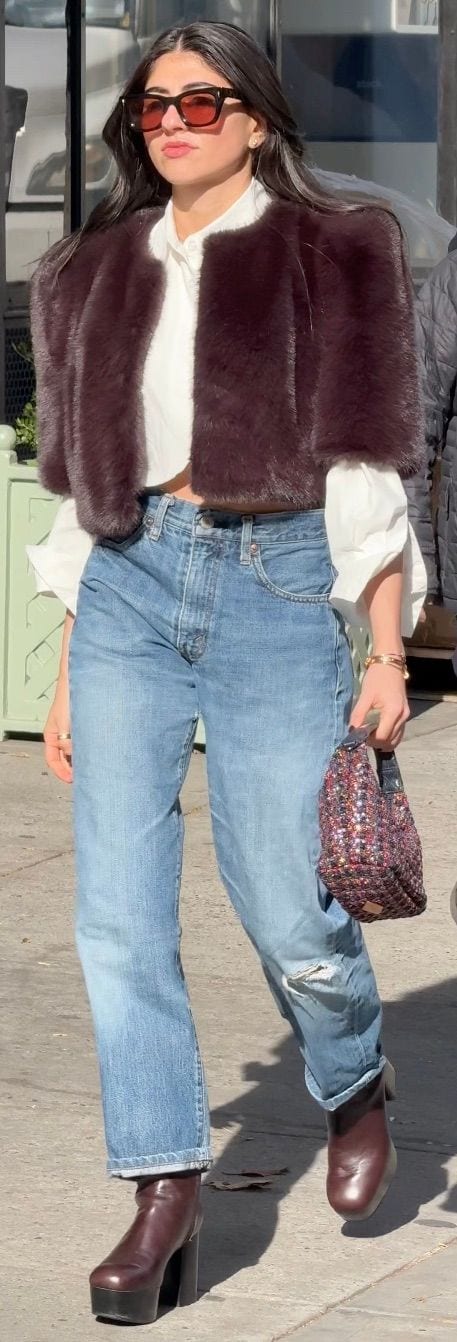Brown faux fur jacket, white shirt, light wash distressed jeans, burgundy platform boots.
