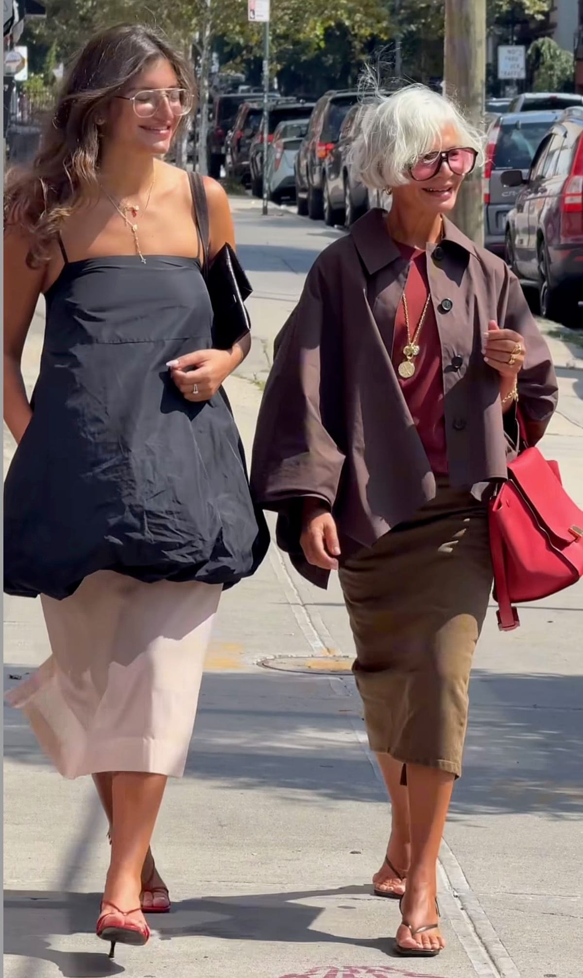 Black bubble top, pale pink skirt, and red heels with a brown jacket, skirt, and red bag.