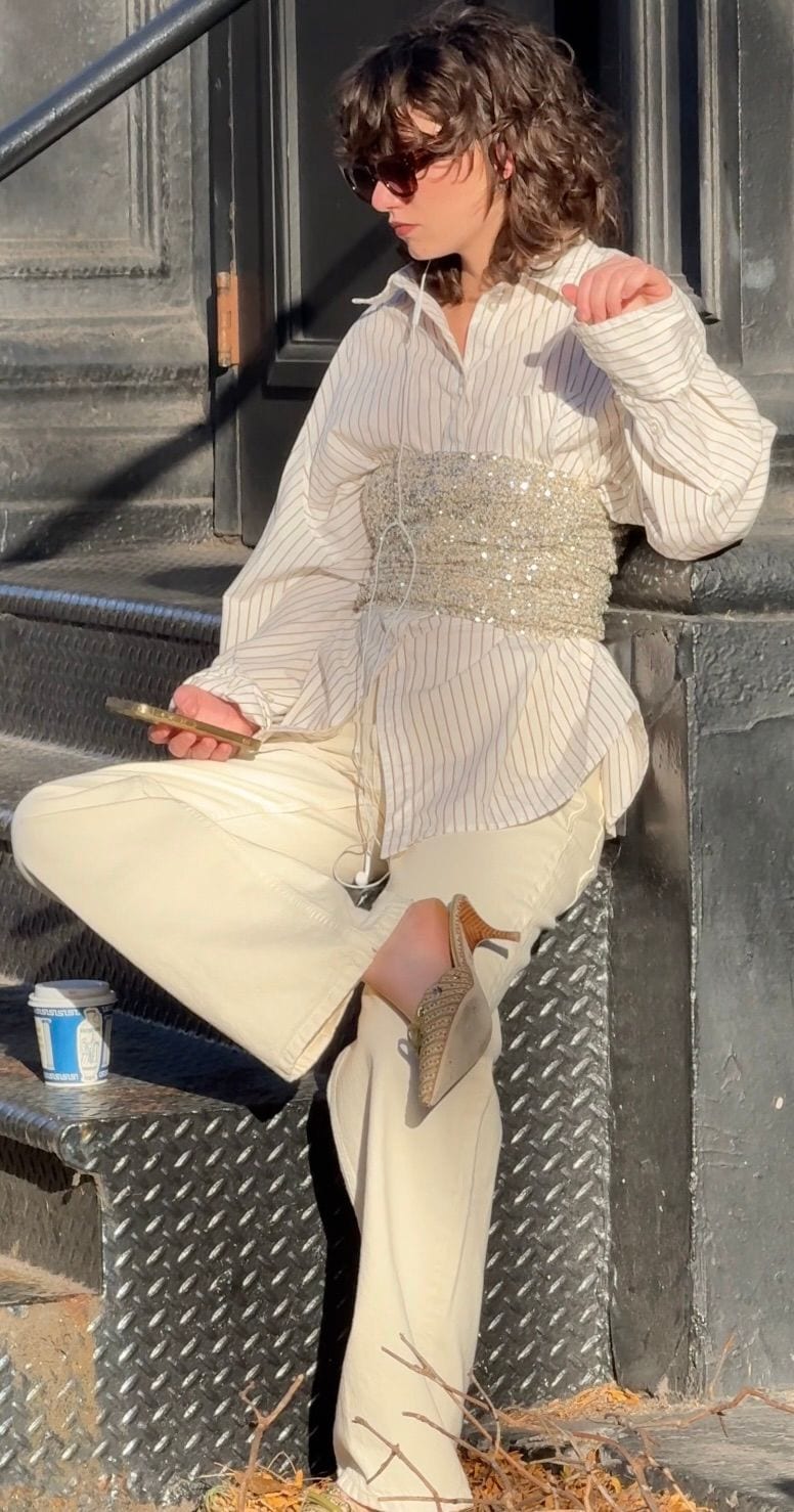 White striped shirt with sequined corset and cream wide-leg pants.