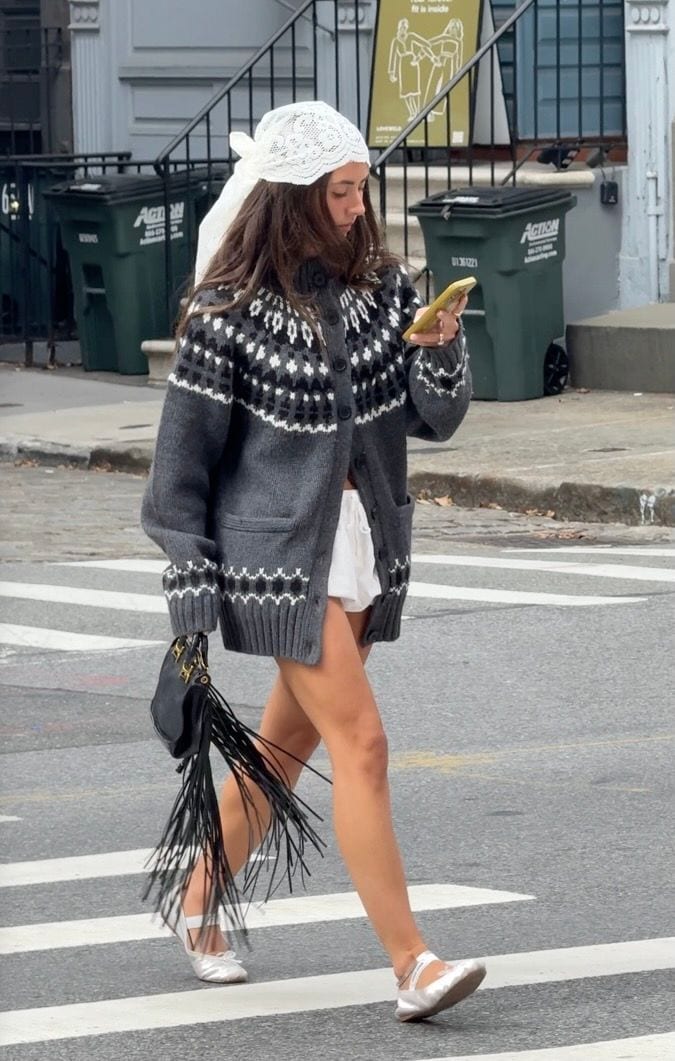 Gray fair isle cardigan, white shorts, white lace headscarf, black fringe bag, and silver ballet flats.