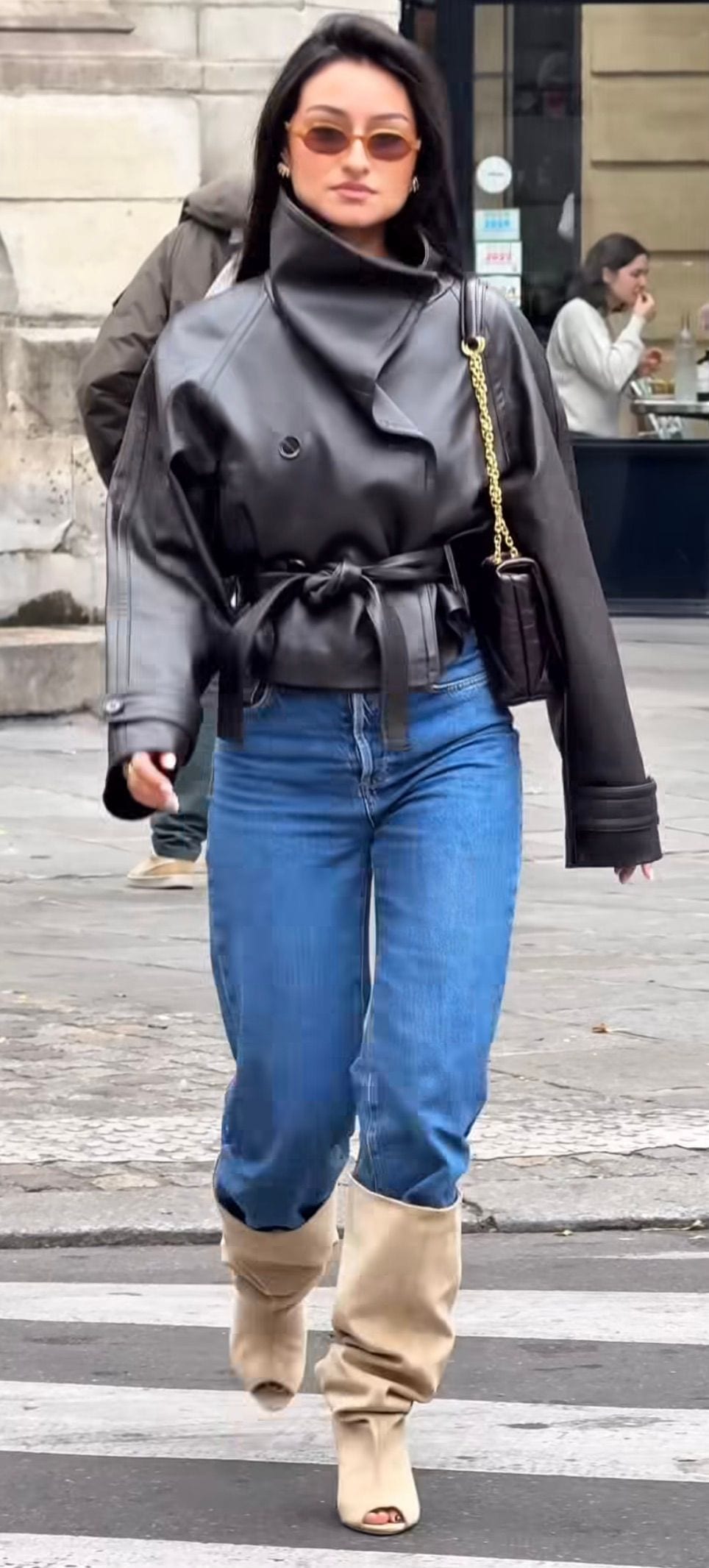 Black leather belted jacket, blue jeans, and tan peep-toe slouch boots.