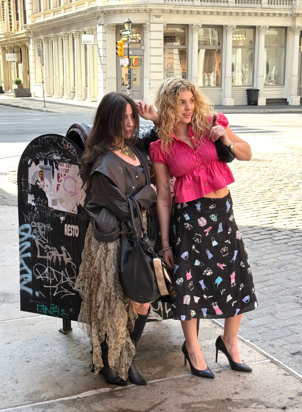 Pink smocked crop top and black printed midi skirt; black leather jacket and ruffled maxi skirt.