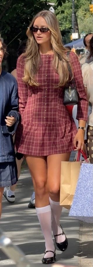 Red plaid mini dress, black sunglasses, white knee-high socks, and Mary Jane shoes.