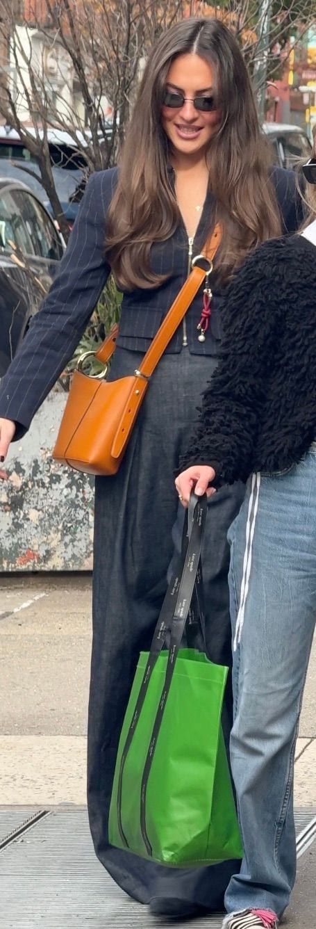 Pinstripe blazer, dark wide-leg pants, brown crossbody bag, and sunglasses.