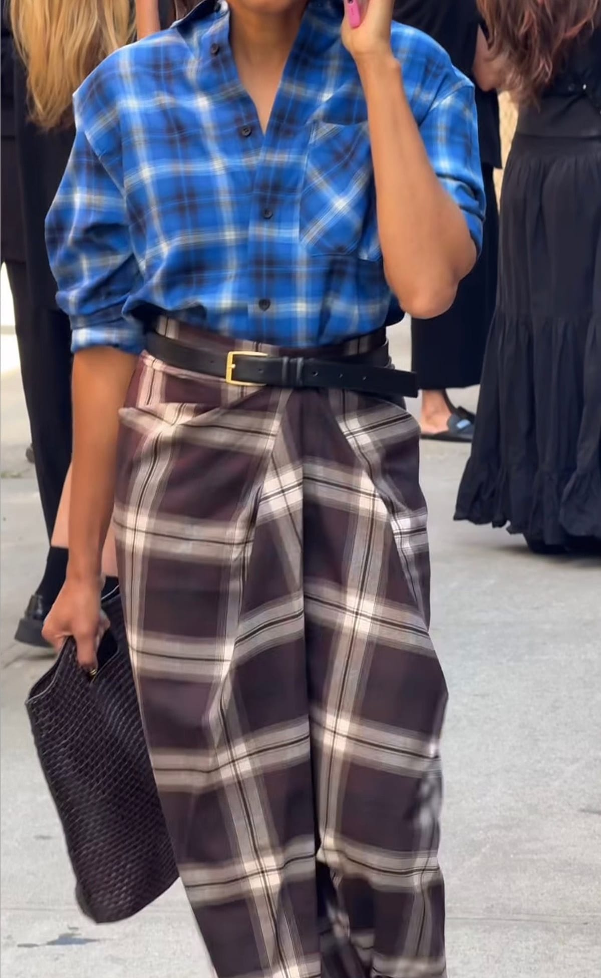 Blue plaid shirt with brown plaid pants, black belt, and black woven bag.