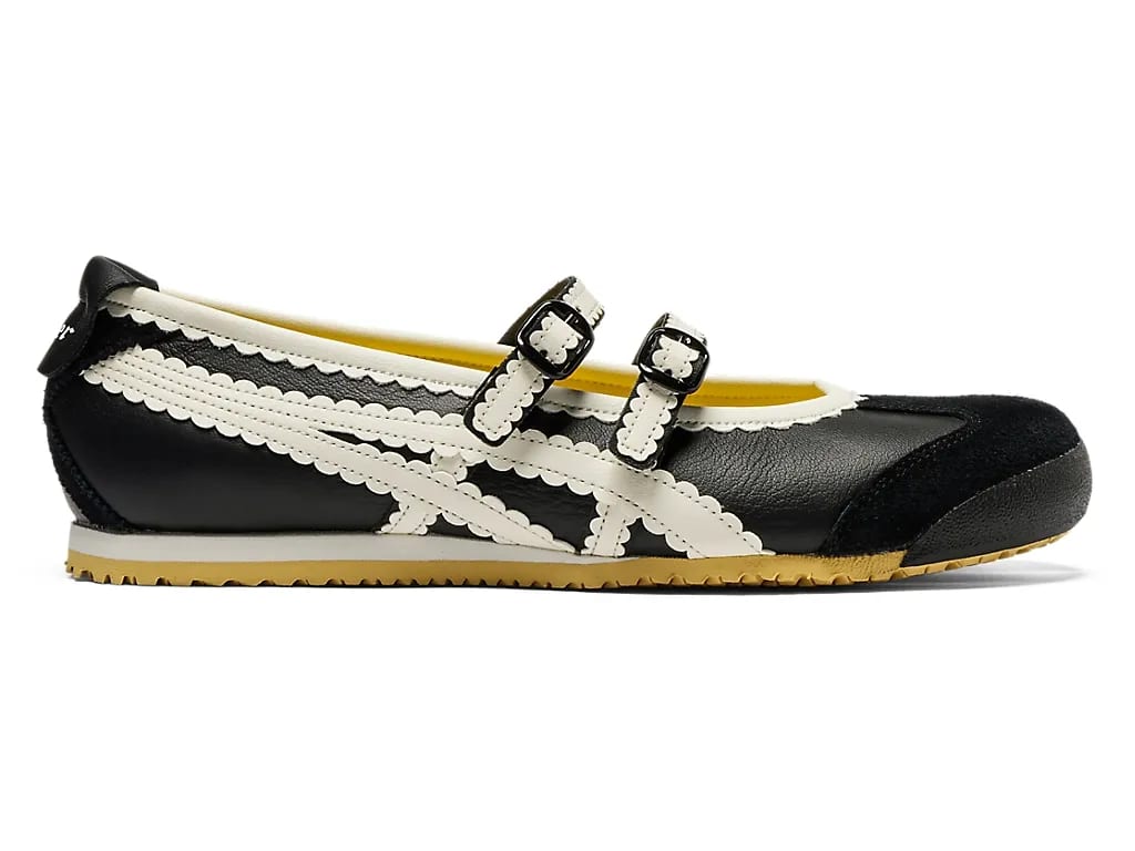 Black and white Mary Jane style shoe with scalloped edges and double buckle straps.