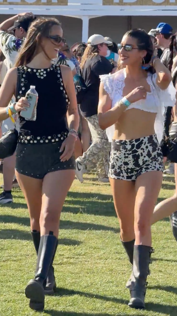 Festival fashion: black studded top, shorts, boots; white lace crop top, cow print shorts, boots.