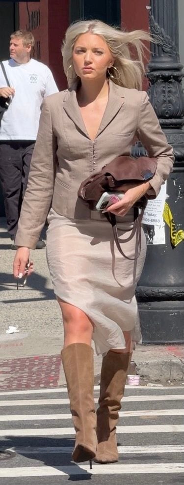 Taupe blazer, champagne slip dress, brown suede knee-high boots, and gold hoop earrings.
