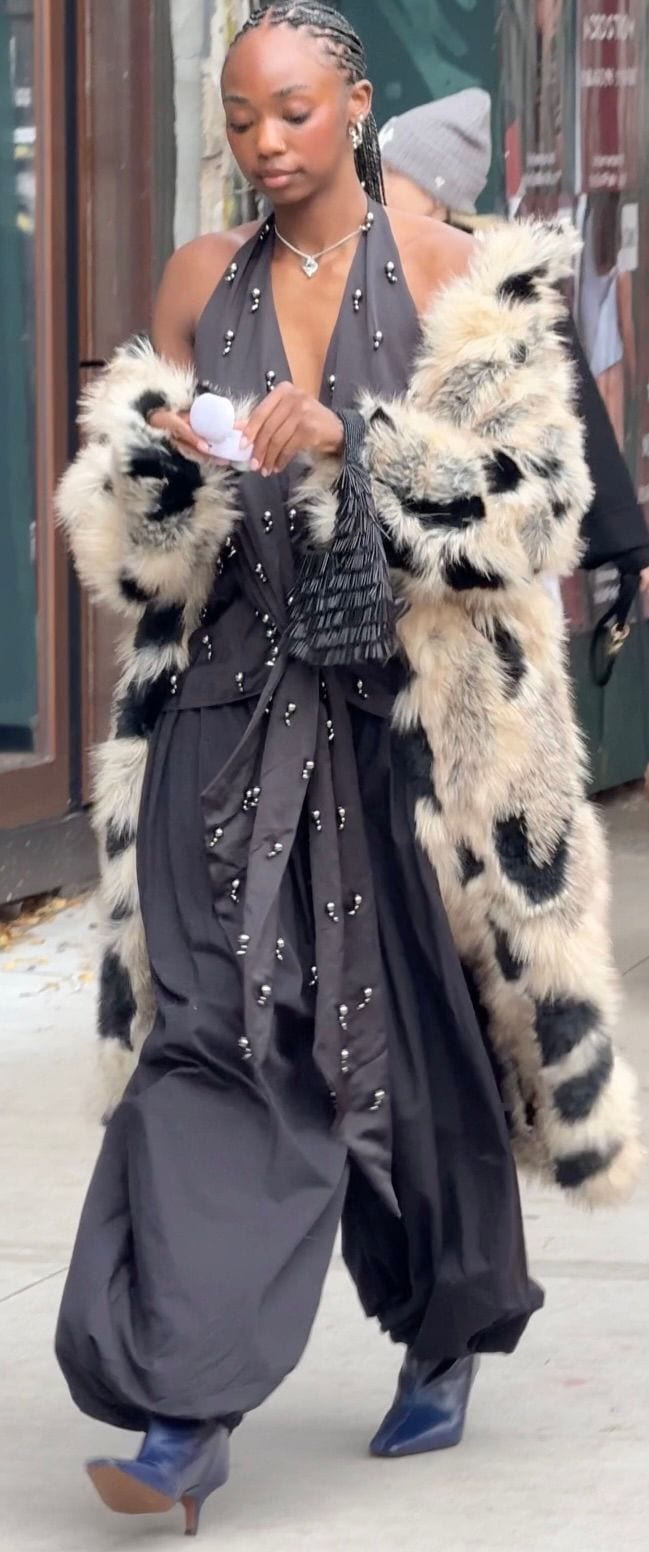 Black halter top and balloon pants, blue boots, and a faux fur cheetah print coat.