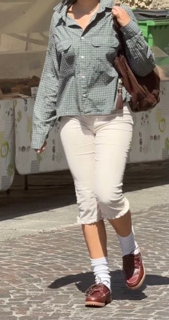 Green plaid shirt, cream capri pants, white socks, and brown chunky loafers.